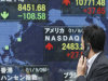 A man walks past an electronic stock board of a securities firm in Tokyo, Monday, Sept 26, 2011.  (AP Photo/Koji Sasahara)