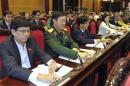 Vietnam's National Assembly's deputies press voting buttons to pass the new constitution during a meeting in Hanoi