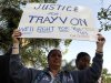 A demonstrator holds up a sign during a rally to call for justice in the murder of Trayvon Martin at Leimert Park in Los Angeles