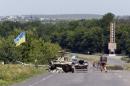 Ukrainian servicemen patrol at a checkpoint outside the eastern Ukrainian town of Slaviansk