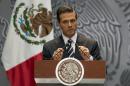President Enrique Pena Nieto adjusts his microphones as he arrives at a press conference to express his outrage over the recent disappearance of 43 students in Guerrero State following a violent confrontation with the police, in Mexico City, Monday, Oct. 6, 2014. Guerrero state officials worked Monday to determine whether 28 bodies found in a clandestine grave are students who were attacked by police suspected of drug gang links in the southern state of Guerrero. (AP Photo/Rebecca Blackwell)