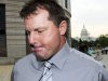 FILE - In this July 6, 2011 file photo, the Capitol is seen in the background, as former Major League Baseball pitcher Roger Clemens arrives at federal court in Washington. On a baseball field, players back up teammates to limit the damage from errors. The Justice Department, embarrassed by an error that caused a mistrial of Roger Clemens last year, has added more prosecutors in hopes of containing any missteps as it seeks to convict the famed pitcher of lying to Congress when he said he never used performance-enhancing drugs.  (AP Photo/Cliff Owen, File)