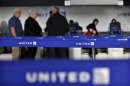 Customers of United wait in line to check in at Newark International airport in New Jersey