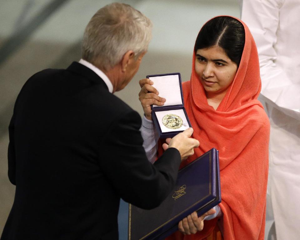 Nobel Peace Prize winner Malala Yousafzai from Pakistan receives her  award from Chair of the Norwegian Nobel Committee, Thorbjorn Jagland during the ...