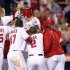 Los Angeles Angels' Mark Trumbo is mobbed at the plate by teammates after hitting a walk-off home run to defeat the New York Yankees during the ninth inning of their MLB baseball game in Anaheim