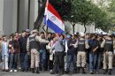 Supporters of Paraguayan President Lugo wait outside the Congress building, before Lugo's impeachment in Asuncion