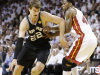 San Antonio Spurs center Tiago Splitter (22) moves the ball against Miami Heat power forward Udonis Haslem (40) during the first half of Game 2 of the NBA Finals basketball game, Sunday, June 9, 2013 in Miami. (AP Photo/Lynne Sladky)