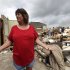 Sherry Enochs, stands in what is left of her home as she recounts the tornado that struck her home Wednesday, April 4, 2012, in Forney, Texas. Enochs was babysitting three children all under the age of 3, when the tornado struck. All survived the storm with minor bumps and bruises.  (AP Photo/Tony Gutierrez)