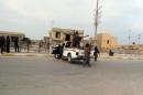 Armed men roam a street in the western, mainly Sunni Muslim city of Ramadi, the capital of the Anbar province, on January 4, 2014