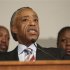 Reverend Al Sharpton speaks while flanked by Trayvon Martin's parents Tracy Martin and Sybrina Fulton during a press conference in response charges brought against George Zimmerman at the Washington Convention Center in Washington D.C.