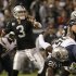 Oakland Raiders quarterback Carson Palmer (3) passes as running back Darren McFadden (20) upends San Diego Chargers linebacker Donald Butler (56) during the first quarter of an NFL football game in Oakland, Calif., Monday, Sept. 10, 2012. (AP Photo/Jeff Chiu)
