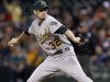 Oakland Athletics starting pitcher Brandon McCarthy delivers against the Seattle Mariners in the first inning of a baseball game, Monday, Sept. 26, 2011, in Seattle. (AP Photo/Elaine Thompson)