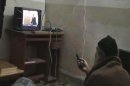 FILE - This undated image from video, seized from the walled compound of al-Qaida leader Osama bin Laden in Abbottabad, Pakistan, and released by the U.S. Department of Defense Saturday, May 7, 2011, shows a man, identified as Osama bin Laden, watching President Barack Obama on his television. A year after the U.S. raid on his compound bin Laden's al-Qaida terror network is hobbled and hunted, but still dreaming of payback. (AP Photo/Department of Defense, File)