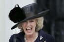 FILE - In this April 12, 2006 file photo, Britain's Camilla, the Duchess of Cornwall, top, laughs as members of the royal family including Queen Elizabeth II, bottom, and Prince Philip leave after the Sovereign's Parade at the Royal Military Academy Sandhurst in England where Prince Harry, received his military commission. Queen Elizabeth II has appointed the Duchess of Cornwall the highest female rank in the Royal Victorian Order, Buckingham Palace said Monday, April 9, 2012. The announcement that Camilla has been made a Dame Grand Cross comes on the day of her seventh wedding anniversary with Prince Charles, the queen's son. (AP Photo/Lefteris Pitarakis, File)