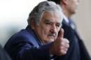 Uruguay's President Jose Mujica waves as he leaves the Itamaraty Palce after the 6th BRICS summit and the Union of South American Nations (UNASUR) in Brasilia