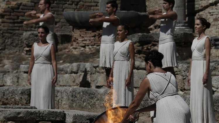 Actress Ino Menegaki as high priestess, lights the Olympic Flame from the sun's rays, during the lighting of the Olympic flame at Ancient Olympia, in west southern Greece on Sunday Sept. 29, 2013. Using the sun's rays at the birthplace of the ancient Olympics, organizers carried out a successful ceremony to light the flame for the 2014 Sochi Winter Olympics Feb. 7-23, 2014 in Russia. (AP Photo (AP Photo/Dimitri Messinis)