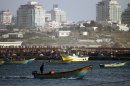 A Palestinian fisherman rides a boat near the port of Gaza City on March 22, 2013