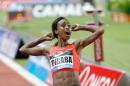 Ethiopia's Genzebe Dibaba wins the 1500m women's race and sets a new world record, at the Herculis International Athletics Meeting, at the Louis II Stadium in Monaco, Friday, July 17, 2015. (AP Photo/Claude Paris)