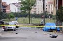 Police forensic experts examine a scene following a vehicle explosion near a military facility in Istanbul