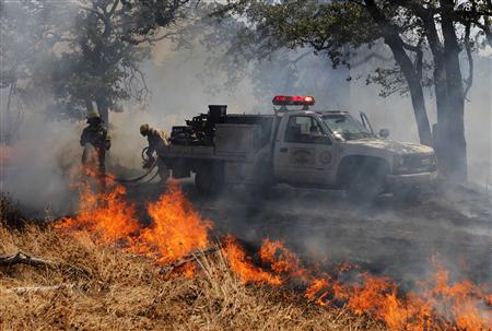 Firefighters battle wildfire near the town of Noble in Cleveland County south of Oklahoma City
