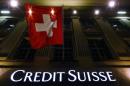 Logo of Swiss bank Credit Suisse is seen below the Swiss national flag at a building in the Federal Square in Bern
