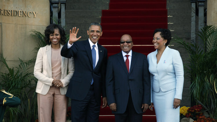 U.S. President Barack Obama flanked by First Lady Michelle Obama, left, waves with South African President Jacob Zuma, second right, and his wife Tobeka Madiba Zuma, right, on the steps of Union Building in Pretoria, South Africa, Saturday June 29, 2013. (AP Photo/Jerome Delay)