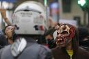 A demonstrator wears a mask during a protest against the fare hike on public transportation in Sao Paulo, Brazil, Tuesday, Jan. 12, 2016. The protests were organized by the Free Fare Movement, the same group that initiated mass anti-government demonstrations that filled streets across Brazil in 2013. (AP Photo/Nelson Antoine)