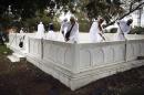 Shi'ite Muslim pilgrims from India clean a shrine on the grounds of Barzilai Medical Center in Ashkelon