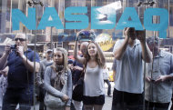 Curious bystanders watch through the Nasdaq windows as Facebook shares begin trading, Friday, May 18, 2012 in New York. The social media company priced its IPO on Thursday at $38 per share, and beginning Friday regular investors will have a chance to buy shares. (AP Photo/Richard Drew)