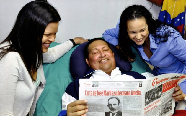 Venezuela's President Chavez holds a copy of the newspapers while recovering from cancer surgery in Havana