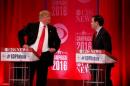 Republican U.S. presidential candidate Trump speaks with Rubio during a commercial break at the Republican U.S. presidential candidates debate sponsored by CBS News and the Republican National Committee in Greenville