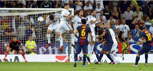Barcelona's Lionel Messi shoots and scores with a freekick during their Spanish Super Cup second leg soccer match against Real Madrid at Santiago Bernabeu stadium in Madrid