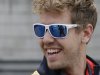 Red Bull driver Sebastian Vettel of Germany smiles as he walks around the circuit ahead of the Chinese Formula One Grand Prix in Shanghai, China, Thursday, April 11, 2013. (AP Photo/Mark Baker)