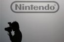 Photographer takes pictures in front of the logo of Nintendo Co Ltd's at its news conference in Tokyo