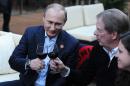 Russian President Vladimir Putin, left, toasts member of the International Olympic Committee Larry Probst while visiting USA House during the 2014 Winter Olympics, Friday, Feb. 14, 2014 in Sochi, Russia. (AP Photo/RIA-Novosti, Mikhail Klimentyev, Presidential Press Service)