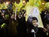 In this photo taken Tuesday, July 26, 2011, Hezbollah supporters wave the party's flags and carry pictures of Hezbollah leader Hassan Nasrallah during a rally marking the fifth anniversary of the 2006 Israel-Hezbollah war, in Beirut's southern suburb, Lebanon. Militarily and politically, Hezbollah may be stronger than ever, but in a fast changing Arab world, the Shiite Muslim group is facing some of the biggest challenges to its role and legitimacy yet since its creation as a resistance group to fight Israeli occupation in the mid 1980s.  (AP Photo/Bilal Hussein)