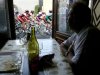 File photo of a man in a cafe looking out of the window at a pack of riders participating in the Tour de France cycling race between Nevers and Lyon