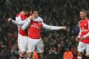 Arsenal's Alexis Sanchez, center, celebrates scoring a goal with teammate Oliver Giroud during the English Premier League soccer match between Arsenal and Queens Park Rangers at the Emirates Stadium, London, Friday, Dec. 26, 2014. (AP Photo/Tim Ireland)