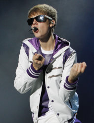 FILE - In this Oct. 17, 2011 file photo, singer Justin Bieber performs during his My World Tour concert at the National Stadium in Lima, Peru. A spokeswoman for Bieber says there is no truth that the singer fathered a baby by a woman who has filed a paternity suit against the teen heartthrob. Melissa Victor said in a statement Wednesday, Nov. 2, that Bieber's camp will pursue all legal remedies in response to the allegation. Online court records show Mariah Yeater filed a paternity lawsuit against Bieber on Monday in San Diego Superior Court. (AP Photo/Enrique Castro Mendivil, Pool)