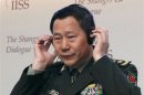 China's People's Liberation Army Deputy Chief of General Staff, Lieutenant General Qi Jianguo, adjusts his headset before fourth plenary session of IISS Asia Security Summit in Singapore
