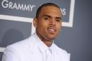 FILE - In this Feb. 10, 2013 file photo, Chris Brown arrives at the 55th annual Grammy Awards, in Los Angeles. Brown was arrested early Sunday, Oct. 27, 2013 in Washington after a fight broke out near the W Hotel near the White House. District of Columbia Police spokesman Officer Paul Metcalf says 24-year-old Brown was arrested and charged with felony assault. Metcalf says 35-year-old Chris Hollosy also was arrested on felony assault charges after the incident. (Photo by Jordan Strauss/Invision/AP, File)