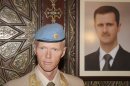 Norwegian Maj. Gen. Robert Mood, head of the U.N. observer team in Syria, is seen next to a portrait of President Bashar Assad after his arrival in Damascus, Sunday, April 29, 2012. Under the peace plan, the U.N. is to deploy as many as 300 truce monitors. One hundred should be in the country by mid-May, and the head of the observer team, Norwegian Maj. Gen. Robert Mood, arrived in Damascus on Sunday to assume command, according to the mission's spokesman, Neeraj Singh.(AP Photo/Bassem Tellawi)