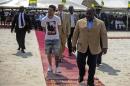 Argentinian soccer player Lionel Messi (C) is given a tour during the start of construction of the Port-Gentil Stadium by the President of Gabon, Ali Bongo Ondimba (R) in the Ntchengue district of Port-Gentil on July 18, 2015