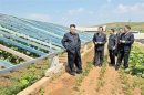 KCNA picture shows North Korean leader Kim Jong-un visiting vegetable greenhouses at the Songhak Co-op Farm in Anju City, South Pyongan Province