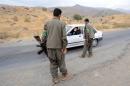 Kurdistan Worker's Party (PKK) rebels stop a car at a security checkpoint near a PKK base in the Qandil mountains in northern Iraq