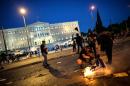 Protesters burn a Greek flag in central Athens, during an anti-austerity protest on July 15, 2015