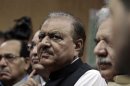 Mamnoon Hussain, presidential candidate of the Pakistan Muslim League-Nawaz party, stands as he submits his nomination papers for the upcoming presidential election in Islamabad