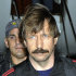 FILE - This Tuesday Nov. 16, 2010 file photo provided by the Drug Enforcement Administration shows Russian arms trafficking suspect Viktor Bout, center, in U.S. custody after being flown from Bangkok to New York in a chartered U.S. plane. The trial of Bout, dubbed the Merchant of Death, began Wednesday, Oct. 12, 2011 in federal court in New York. Bout is accused of attempting to sell "staggering quantities" of weapons and explosives to anti-American rebels to make millions of dollars.  (AP Photo/Drug Enforcement Administration, File)