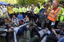 Demonstrators lock themselves together during a protest outside a drill site run by Cuadrilla Resources, near Balcombe in southern England