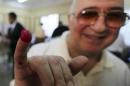 A man shows his ink-marked finger after casting his vote at a polling station during the Egyptian presidential election in Cairo